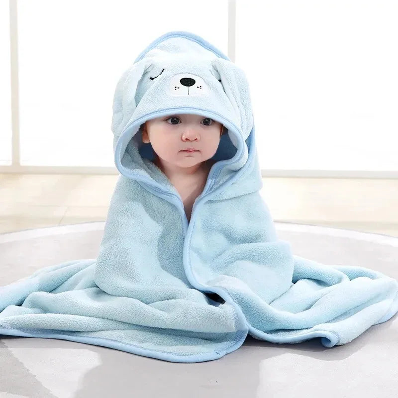 A collection of soft hooded baby towels in blue, gray, white, and pink colors, each with a cute animal face pattern.