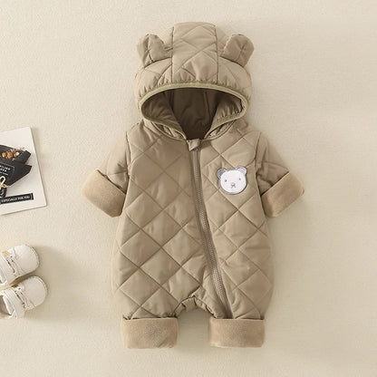 Quilted baby snowsuit with bear ears and face on a beige background