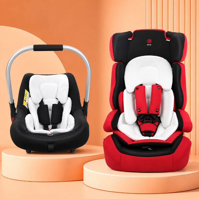 Two infant car seats displayed on peach pedestals: a black and white baby car seat in a bassinet style on the left, and a red, white, and black convertible car seat on the right. The right car seat has a visible red circular logo on the headrest area.