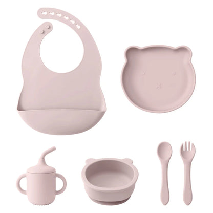 A set of baby feeding supplies in yellow, including a bib, plate, bowl, cup, and utensils with a suction base.