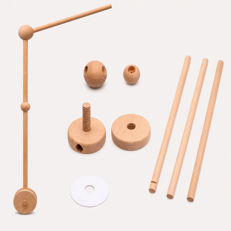 A wooden toy construction set with natural wood pieces including rods, balls, discs, and a white washer, arranged on a light beige background.