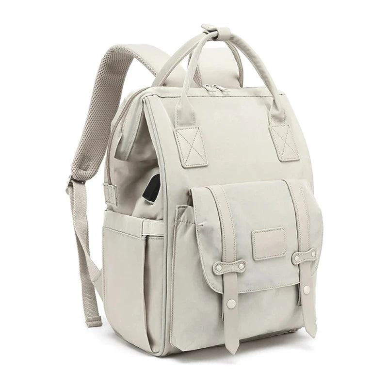 A gray waterproof nappy backpack with multiple compartments and shoulder straps, displayed against a white background.