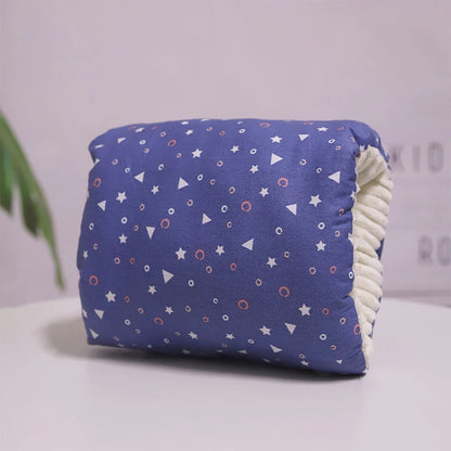 A multicolored nursing arm pillow with a pattern featuring animals and leaves.