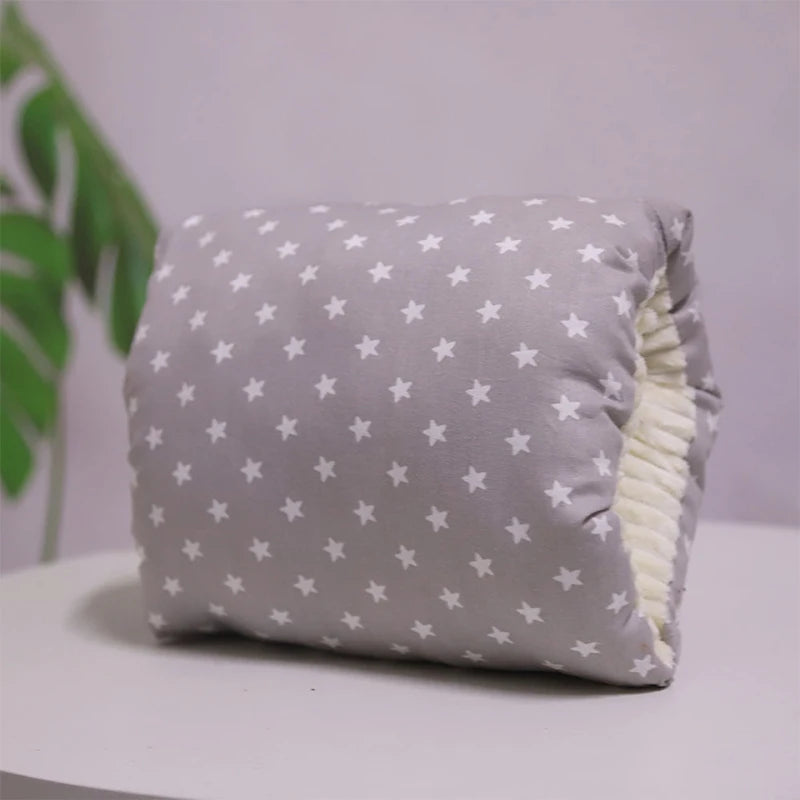 A multicolored nursing arm pillow with a pattern featuring animals and leaves.