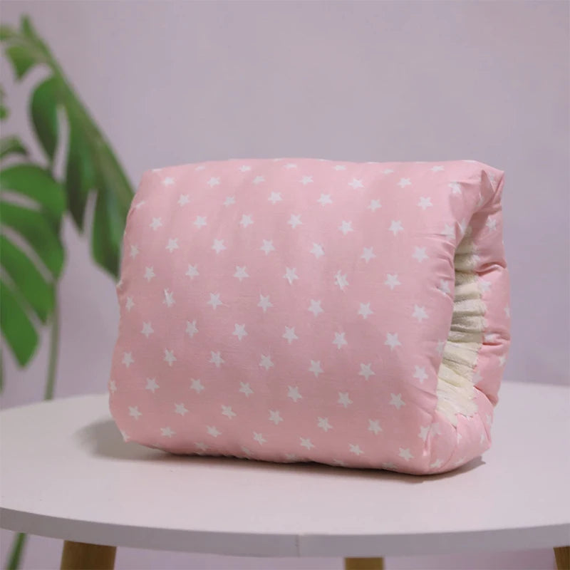 A multicolored nursing arm pillow with a pattern featuring animals and leaves.