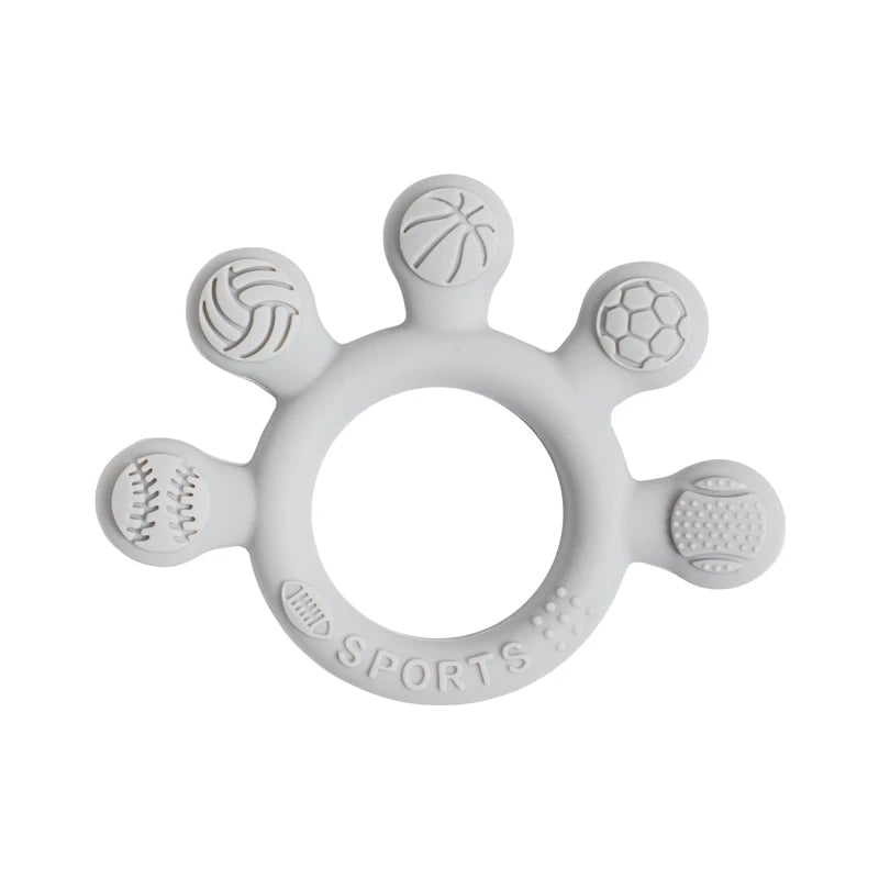 Two silicone baby teether rings with various colorful textures, designed to be held by little hands, placed next to a plush toy on a soft surface.
