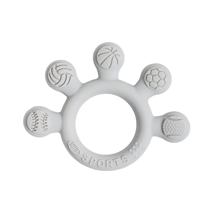 Two silicone baby teether rings with various colorful textures, designed to be held by little hands, placed next to a plush toy on a soft surface.