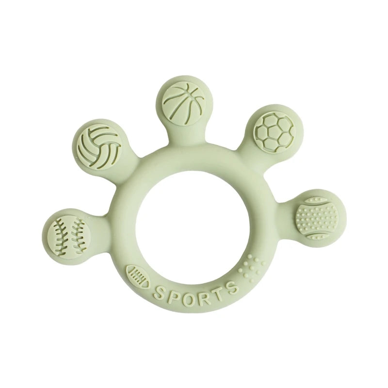 Two silicone baby teether rings with various colorful textures, designed to be held by little hands, placed next to a plush toy on a soft surface.