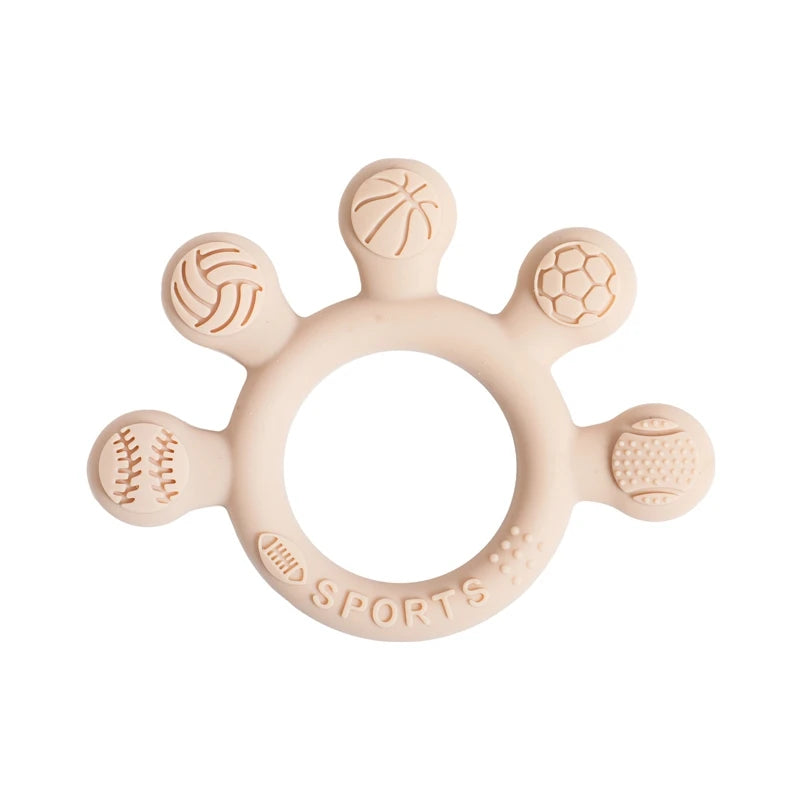 Two silicone baby teether rings with various colorful textures, designed to be held by little hands, placed next to a plush toy on a soft surface.