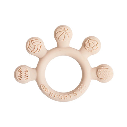 Two silicone baby teether rings with various colorful textures, designed to be held by little hands, placed next to a plush toy on a soft surface.