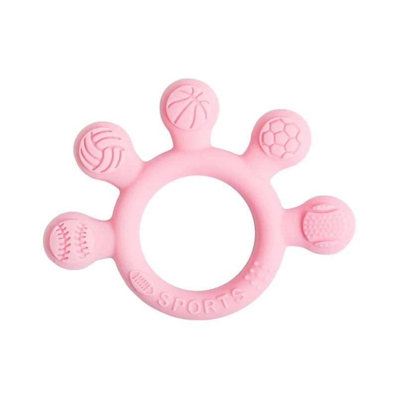 Two silicone baby teether rings with various colorful textures, designed to be held by little hands, placed next to a plush toy on a soft surface.