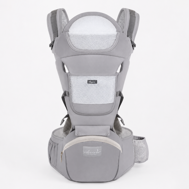 A light gray baby carrier backpack shown from the front on a solid light gray background. The carrier features breathable mesh panels, padded shoulder straps, a waist belt, and a front zippered pocket with a small brand label.