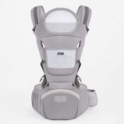 A light gray baby carrier backpack shown from the front on a solid light gray background. The carrier features breathable mesh panels, padded shoulder straps, a waist belt, and a front zippered pocket with a small brand label.
