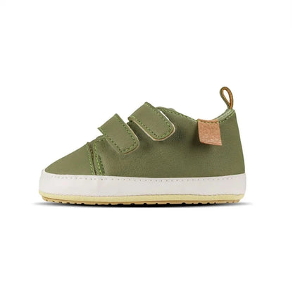 A pair of beige baby sneakers with hook and loop closure and a non-slip sole, designed for comfort and ease of wear for young children.