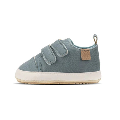 A pair of beige baby sneakers with hook and loop closure and a non-slip sole, designed for comfort and ease of wear for young children.