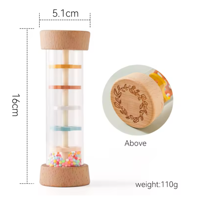 A clear cylindrical toy or storage tube with a light wood top and bottom base, shown on a white background with dimension callouts: 16 cm height, 5.1 cm top diameter, and a circular inset labeled 'Above' showing a close-up of the engraved wood lid.