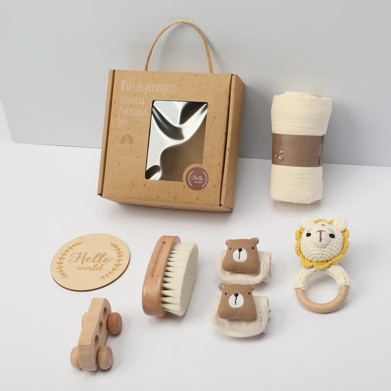 Collection of baby care items including a box, brush, car toy, and rattle on a white background.
