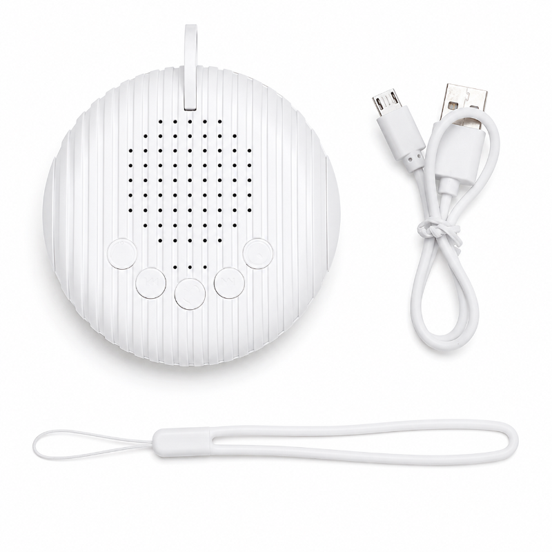 A white portable speaker with a ribbed oval design, shown with a white USB charging cable and a matching wrist strap on a clean white background.